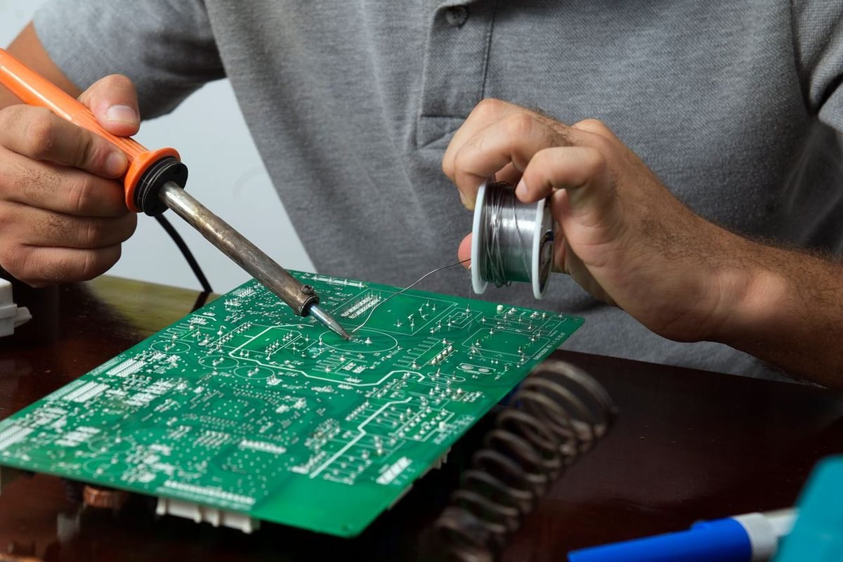 Skilled technician assembling cable harness at Converra Industries